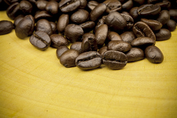 Roasted Coffee Beans background texture on wooden background.