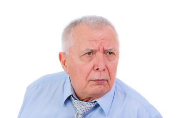 Close-up portrait of serious and strict senior old businessman, dressed in blue shirt and tie, isolated on white background. Human emotions and facial expressions