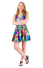 Full length of young cute smile girl stands with crossed hands in mix color summer dress posing isolated on white background, positive human emotion, facial expression