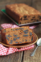 Cake with prunes and almond flour on a old wooden table 