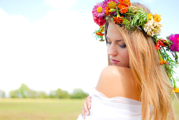 Charming girl wearing flower wreath and white chiffon in