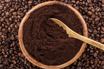 coffee beans and wooden bowl full of ground coffee