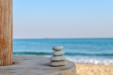 Balanced several Zen stones on blurred beautiful the beach backg