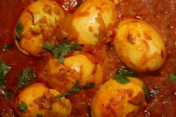 6 eggs are being cooked at vessel and egg curry preparation is going on