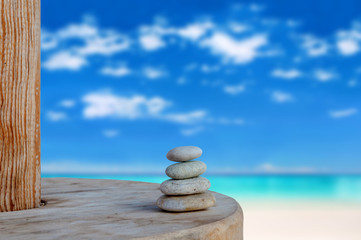 Balanced several Zen stones on blurred beautiful the beach backg