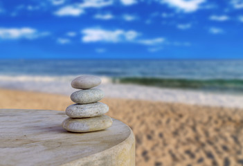 Balanced several Zen stones on blurred beautiful the beach backg