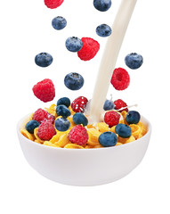 Falling fresh berries and pouring milk in corn flakes