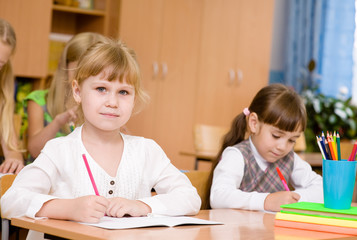 schoolgirl looking at camera during lesson