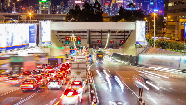 Timelapse video of cross harbour tunnel traffic in Hong Kong at night, camera zooming in
