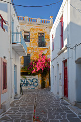 Fototapeta na wymiar Street with traditional architecture in the old part of Parikia which is the capital and main port of Paros island in Greece.