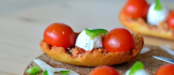 Fresh Italian Bruschetta With Mozzarella And Tomato On A Wooden Table