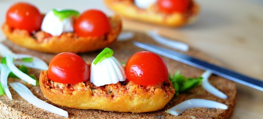 Fresh Italian Bruschetta With Mozzarella And Tomato On A Wooden Table