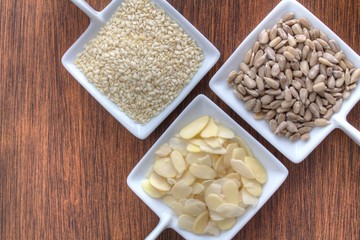 Assortment of three types of seeds including almonds and sunflower seeds