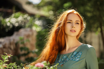 Naklejka premium Art portrait of beautiful girl with long red hair