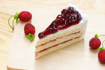 delicious sweet blueberry cheese cake on wooden with strawberry