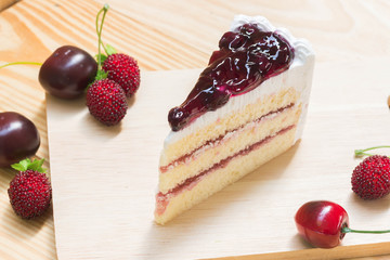 delicious sweet blueberry cheese cake on wooden with strawberry