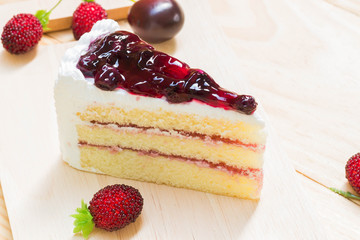 delicious sweet blueberry cheese cake on wooden with strawberry