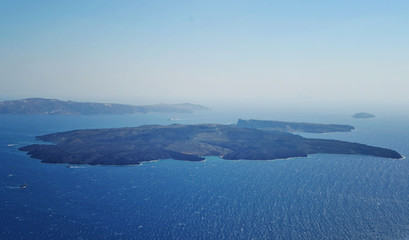 Naklejka na ściany i meble View of the Santorini caldera and Nea Kameni, which is the volcano island in the middle on the cyclades islands.