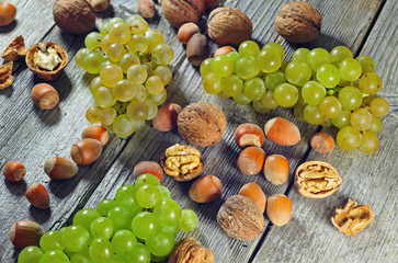 Grapeberries, hazelnuts and walnuts on a wooden table