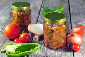 Sauted onions, tomatoes and peppers stored in glass jars for win