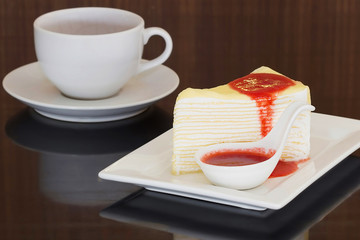 Crepe cake with strawberry sauce