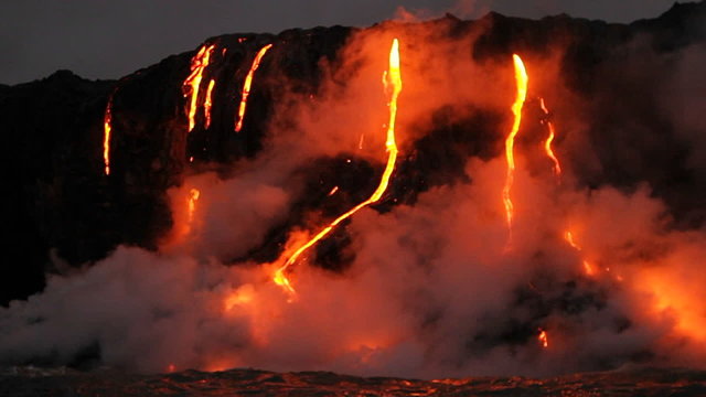 Spectacular dusk lava flow from a volcano into ocean.