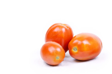 Ripe tomatoes closeup on white background
