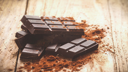 Noble dark chocolate on a wooden table in vintage style.