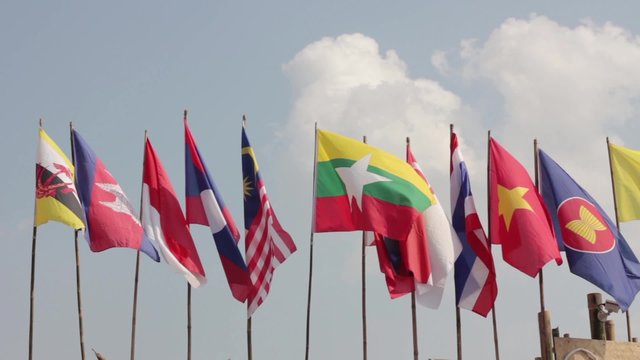 national flags of Southeast asia countries ( ASEAN ) waving atop, blue sky background
