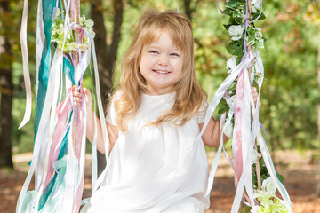 Happy little girl on a swing