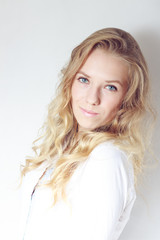 Portrait of young blonde woman with blue eyes