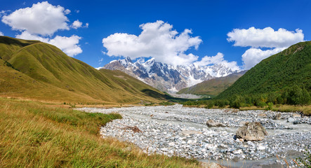 Summer landscape with river and mountain snow. 