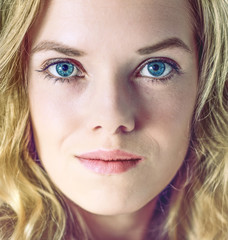 Portrait of young woman with blonde hairs and blue eyes