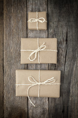 Three gifts wrapped in brown paper