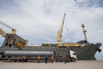 Fototapeta na wymiar Cranes unloading a ship in a harbor