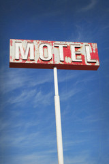 aged and worn vintage photo of old neon motel sign