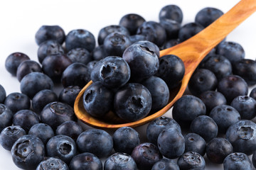 Fresh blueberries in wooden spoon