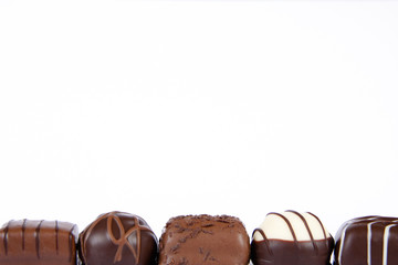 Selection of fine dark, milk and white chocolates in a row