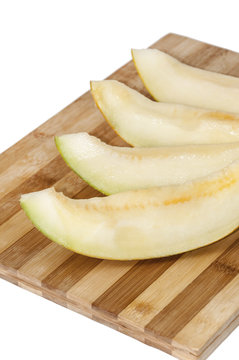 Slices of melon on the kitchen wooden board