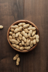 peanuts in wooden bowl on the table