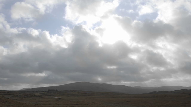 Time lapse of clouds and sun flares over peat bogs at Croagleheen, Ireland.