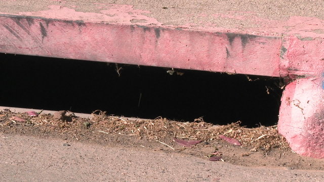 Pan of a Don't Dump Drains to Creek sign in Ojai, California.