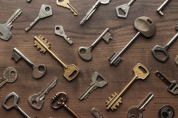many different keys on wooden table