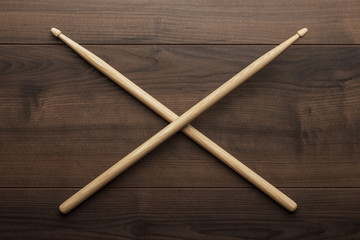 crossed wooden drumsticks on wooden table