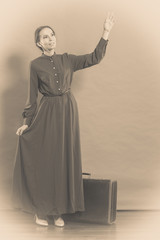 Woman retro style with old suitcase