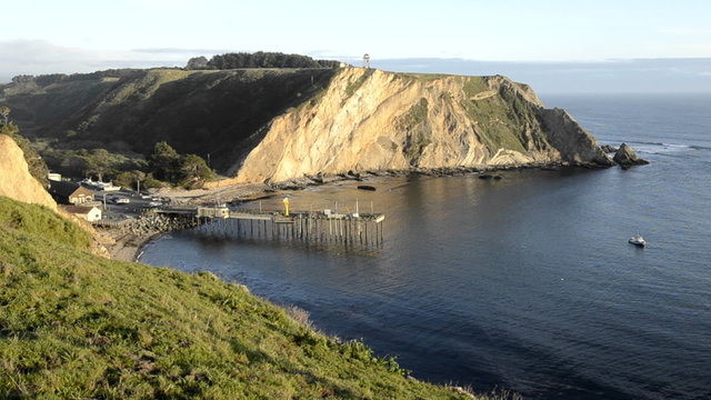 Close up of Arena Cove and a calm ocean at sunset from the Cypress Abbey County property at Point Arena, California.