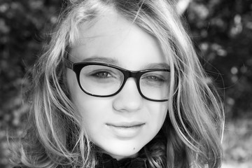 Beautiful blond Caucasian teenage girl in glasses