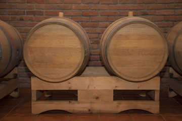 Wooden barrels in a wine cellar.