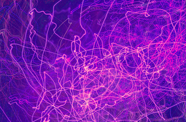 traces of light with different trajectories on blue  background