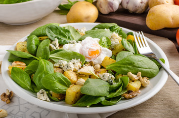 Spinach salad with egg benedict